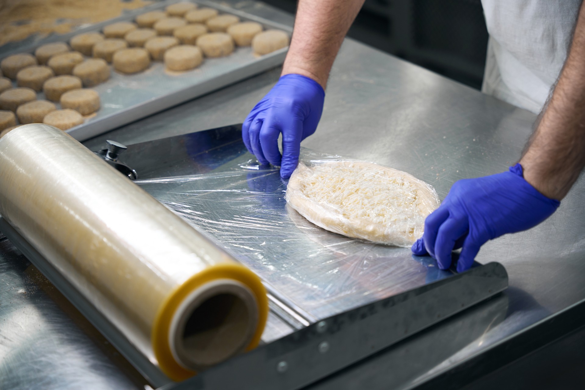 Man packs khachapuri with cheese