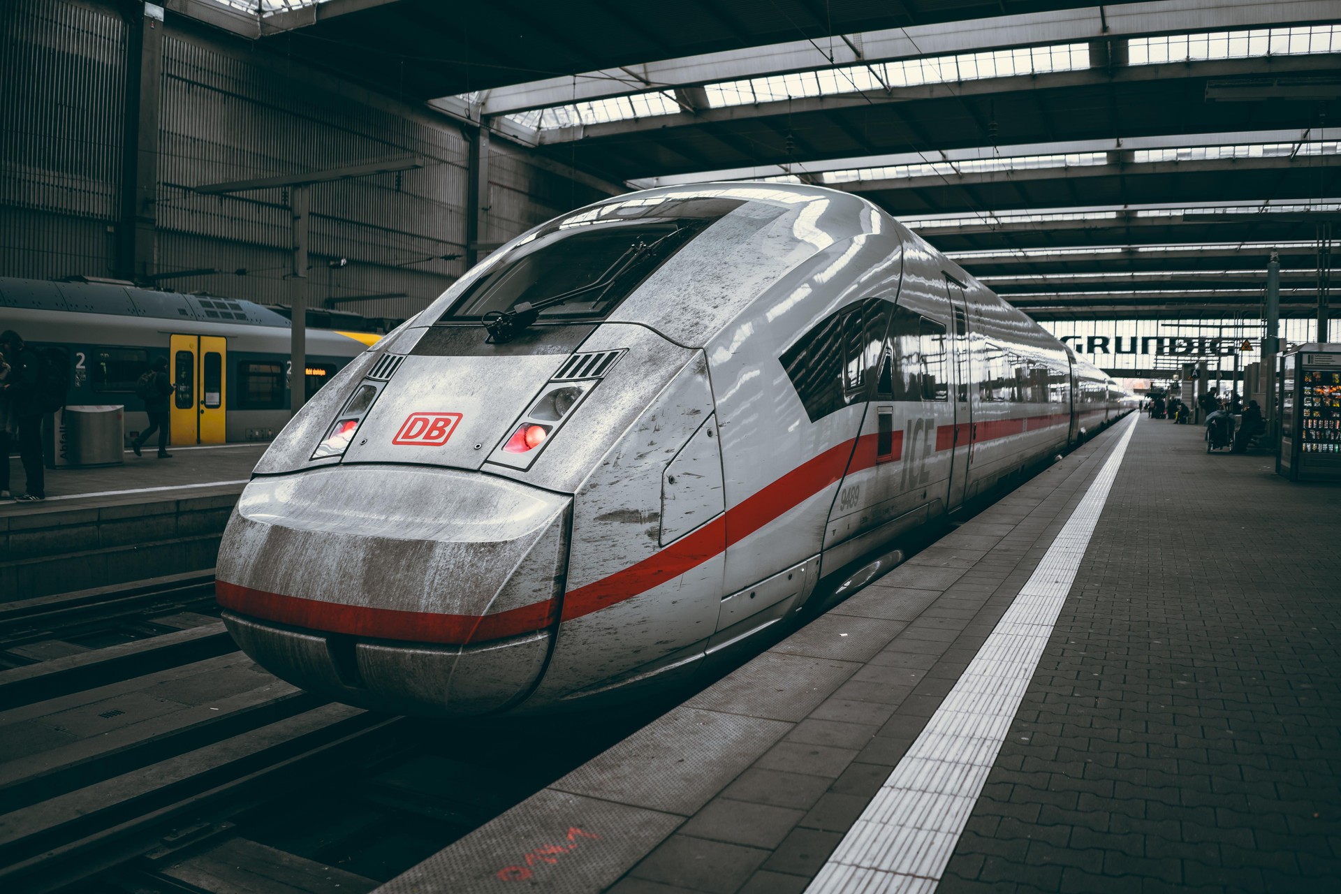 A German high-speed train with a red stripe is parked at a station in Munich, Germany.